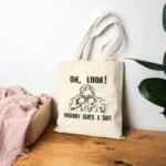 "Nobody Gives A Shit" Funny Sarcastic Tote Bag – Retro Binoculars Graphic – Natural Canvas Carryall - Image 2