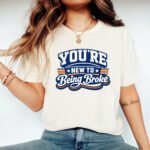 You're New To Being Broke Shirt - Sarcastic Varsity Style T-Shirt - Funny Broke Humor Tee - Retro Typography Graphic Top Apparel Shirt Premium Fitted 100% Cotton Tee