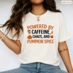 Powered By Caffeine Chaos And Pumpkin Spice T-Shirt, Funny Fall Season Tee, Autumn Coffee Lover Shirt, Thanksgiving Graphic Apparel Clothing Premium Fitted 100% Cotton